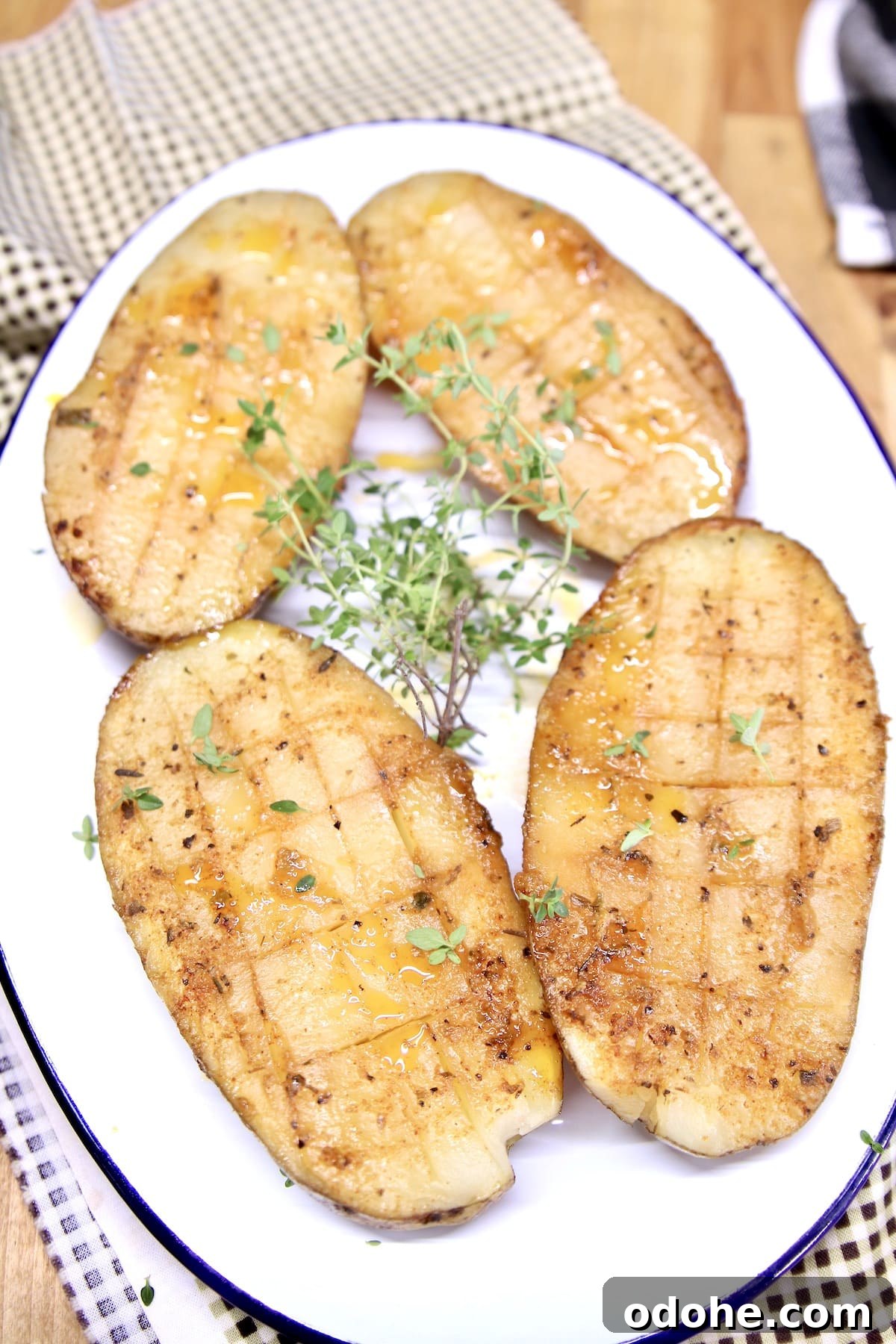 Creole butter baked potatoes on a platter.