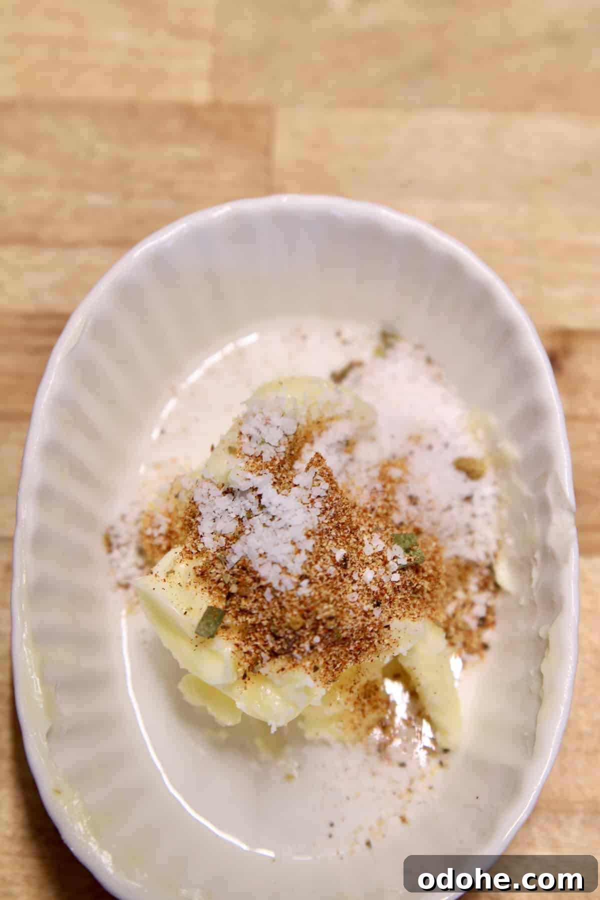 Butter with Creole seasoning in a bowl.