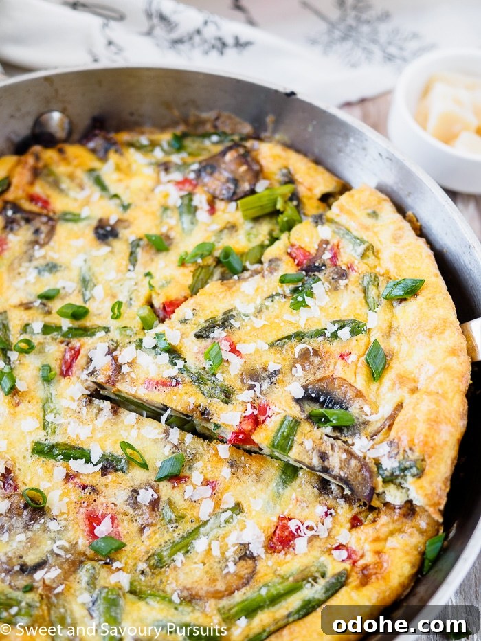 Vegetable Frittata Recipe with Fresh Herbs and Melted Cheese 3 Close-up of a Healthy Vegetable Frittata in a skillet.