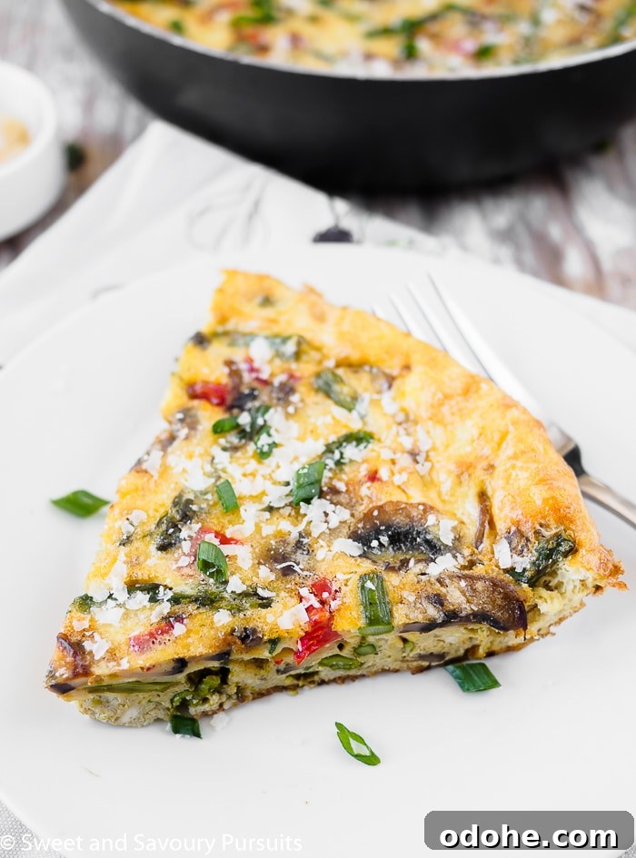 Vegetable Frittata Recipe with Fresh Herbs and Melted Cheese 4 A serving of vegetable frittata on white dish