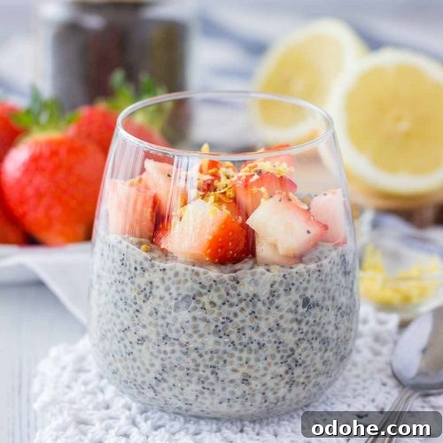 Lemon Poppy Seed Chia Pudding served in a glass topped with fresh strawberries
