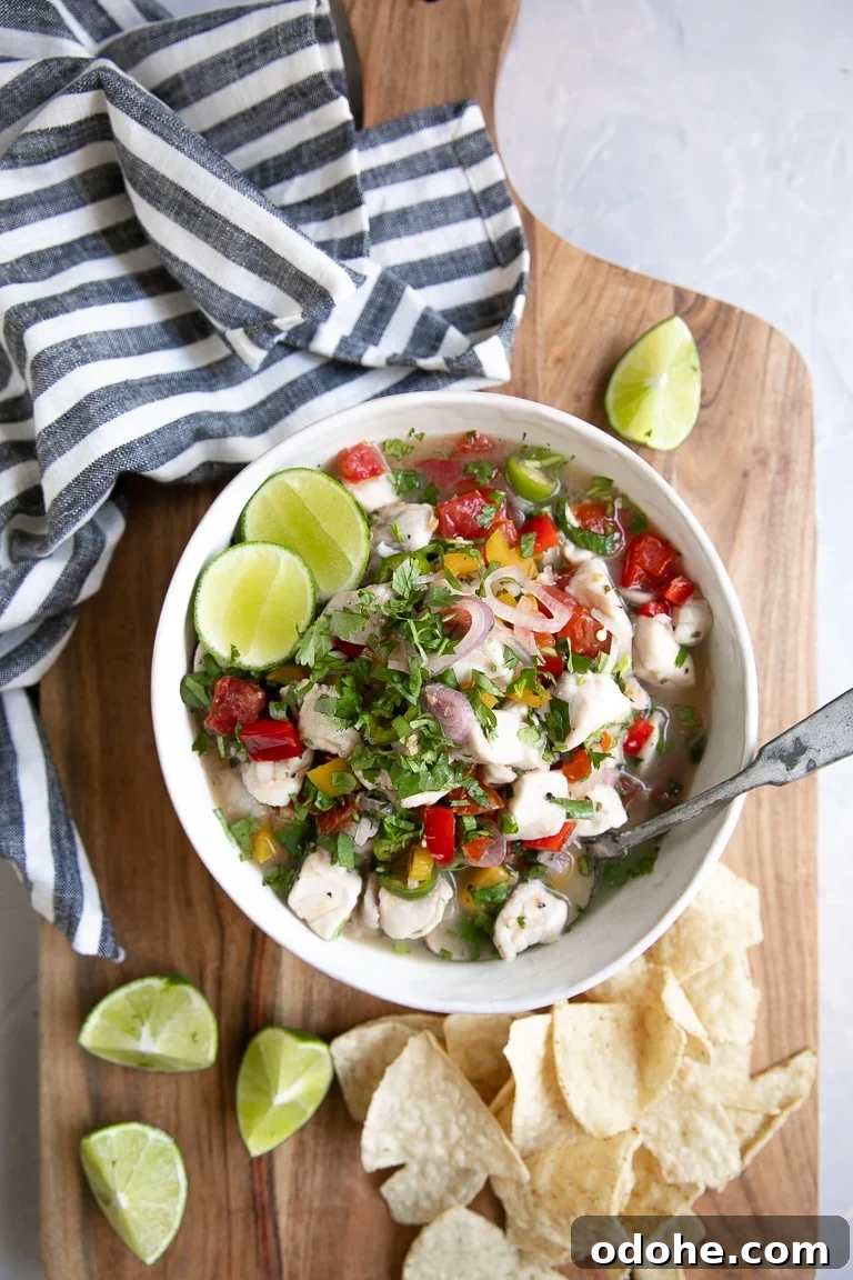 40+ Authentic Mexican Recipes for an Unforgettable Cinco de Mayo 23 Overhead view of a white bowl filled with fish ceviche served with tortilla chips.