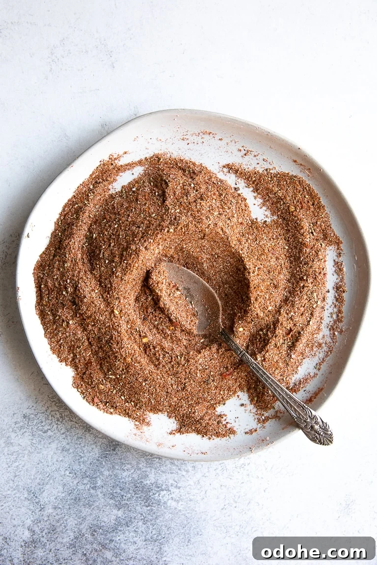 40+ Authentic Mexican Recipes for an Unforgettable Cinco de Mayo 37 A white plate filled with various spices and seasonings blended together to make taco seasoning.