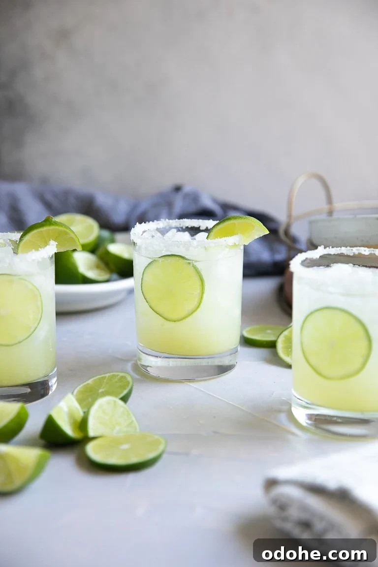 40+ Authentic Mexican Recipes for an Unforgettable Cinco de Mayo 42 Three glasses filled with classic lime margarita on the rocks.