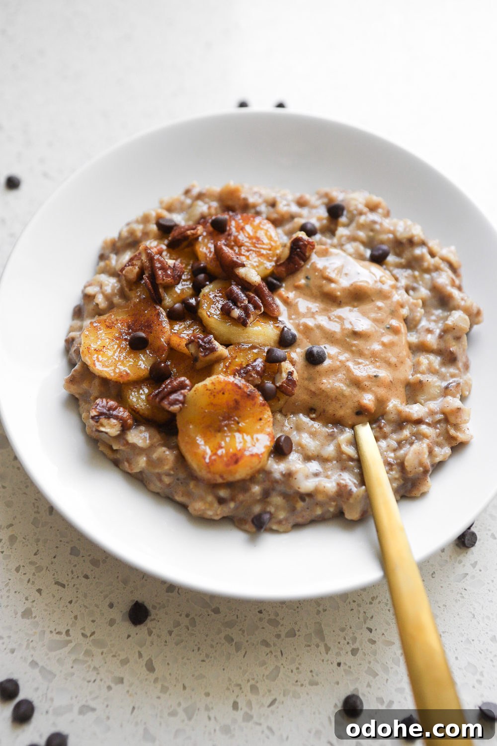 a bowl of vegan banana bread stovetop oatmeal topped with caramelized banana slices 