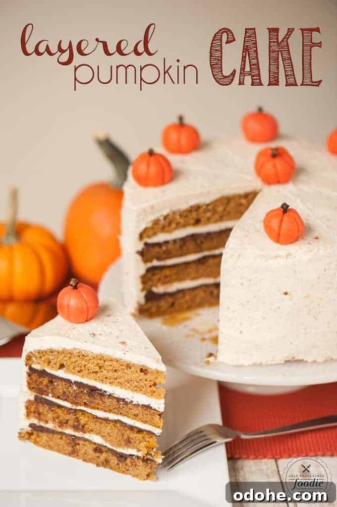 Spiced Layered Pumpkin Cake with Cream Cheese Frosting 2 The frosted layered pumpkin cake being sliced