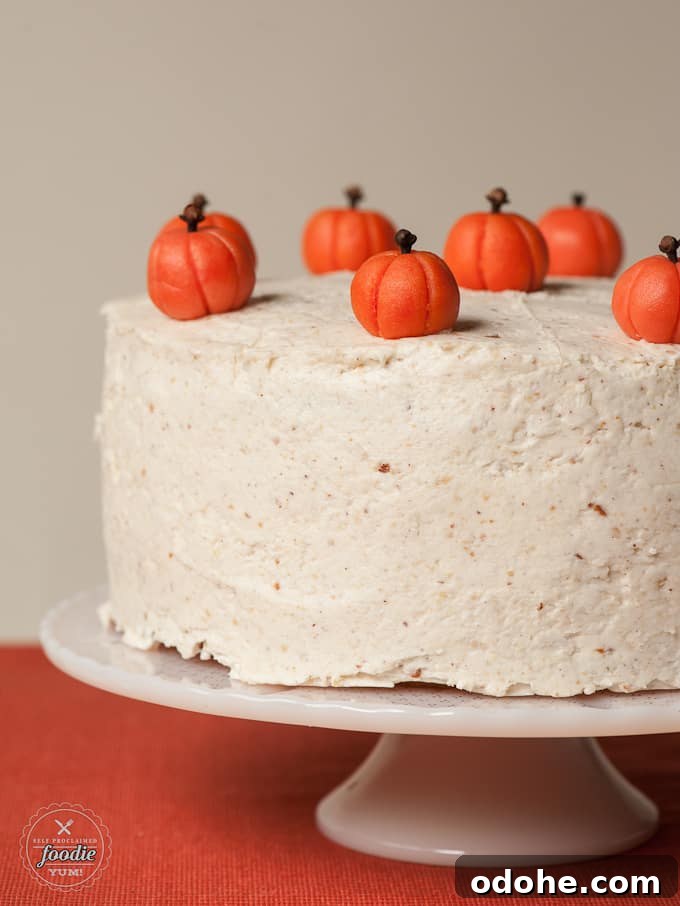 Spiced Layered Pumpkin Cake with Cream Cheese Frosting 4 frosted layered pumpkin cake covered with marzipan pumpkins
