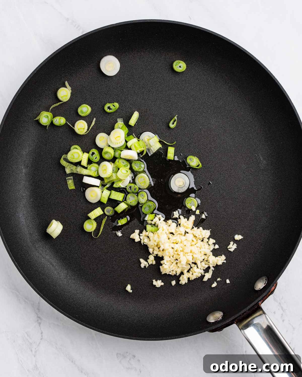 Pan with oil sliced green onions and minced garlic.