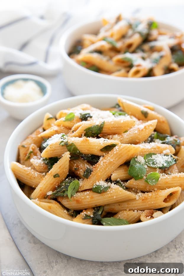 close-up side view of a bowl with penne pasta tossed in an easy sun-dried tomato sauce