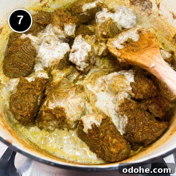 Thai Beef Massaman Curry | cookeatworld.com Coconut milk being added to beef in Massaman curry.