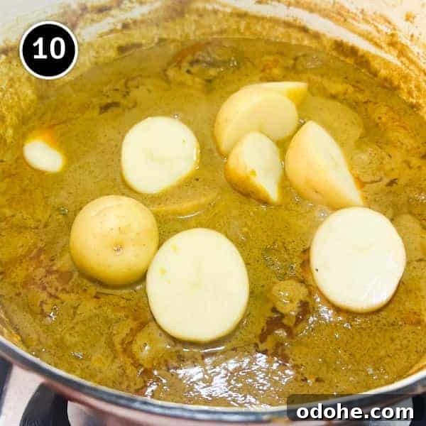 Thai Beef Massaman Curry | cookeatworld.com Potatoes being added to a Thai Massaman curry