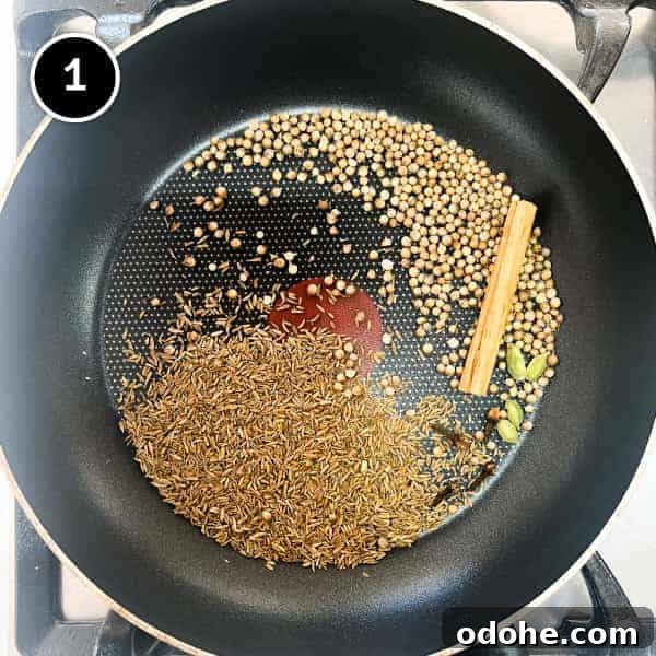 Thai Beef Massaman Curry | cookeatworld.com Whole spices being dry fried in a small frying pan.