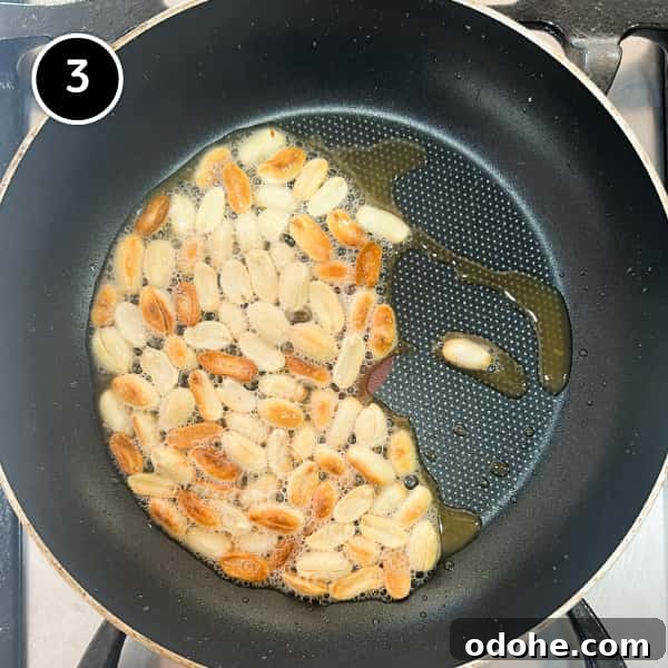 Thai Beef Massaman Curry | cookeatworld.com Peanuts frying in a small pan.