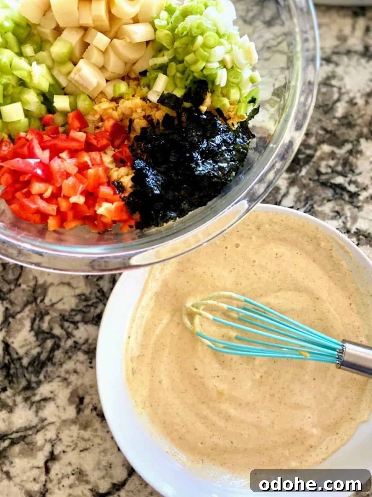 Hearts of Palm Vegan Lobster Roll Recipe 6 Sauce in a bowl with salad in a bowl.