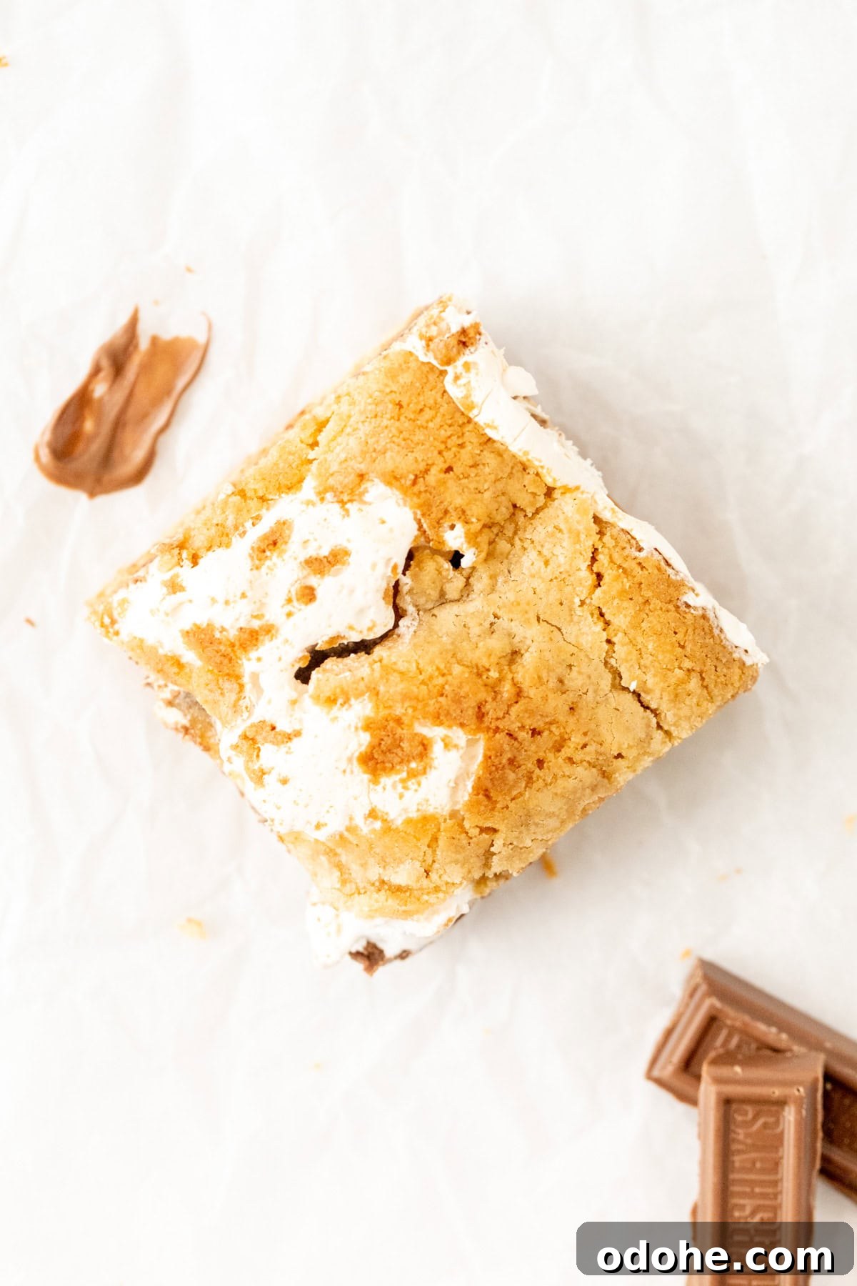 Chewy S'mores Cookie Bars 3 S'mores blondie cut into a square, with marshmallow fluff