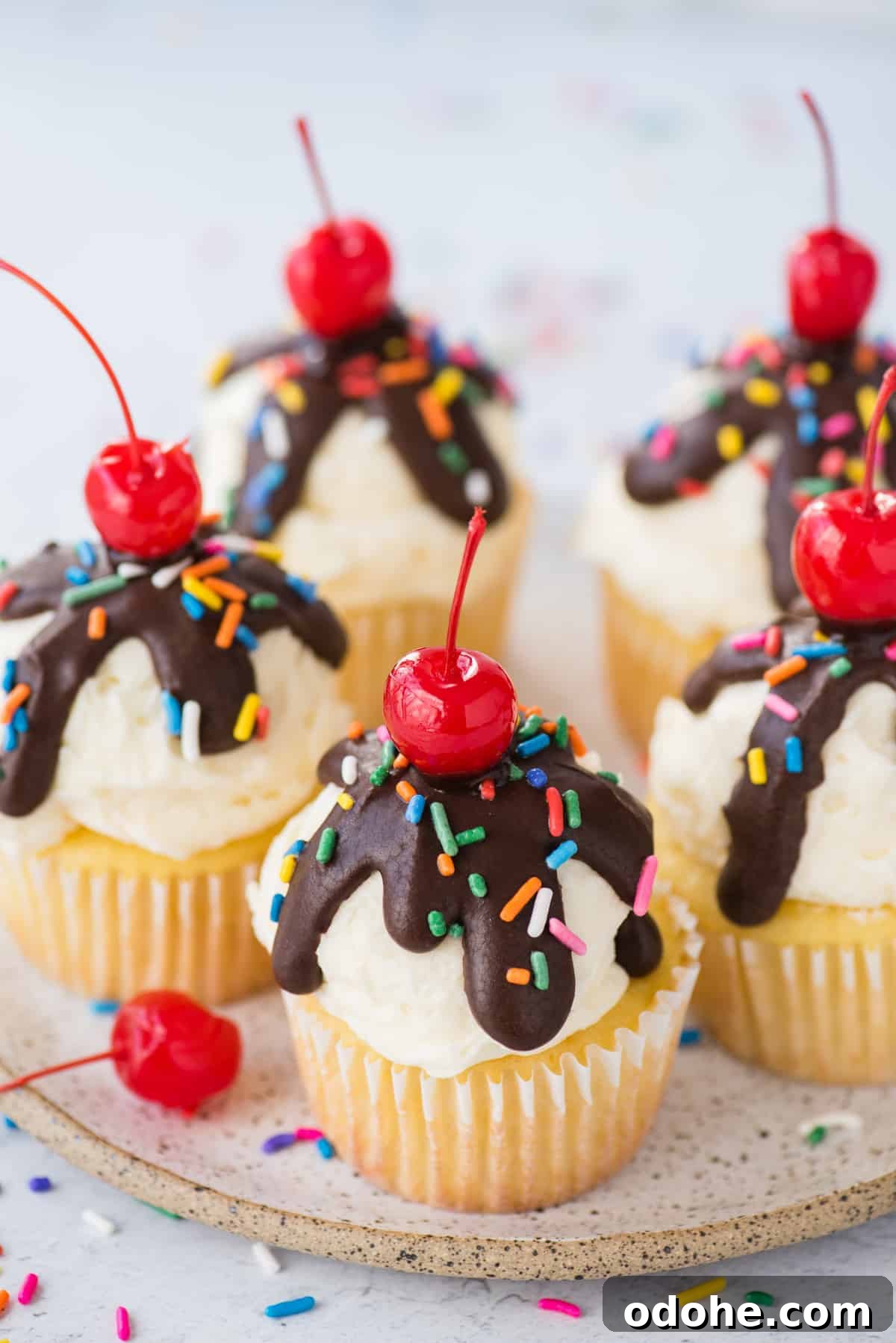 Ice Cream Cupcakes Recipe: Creamy No-Bake Dessert Cups 8 ice cream cupcakes displayed on white speckled plate on white background