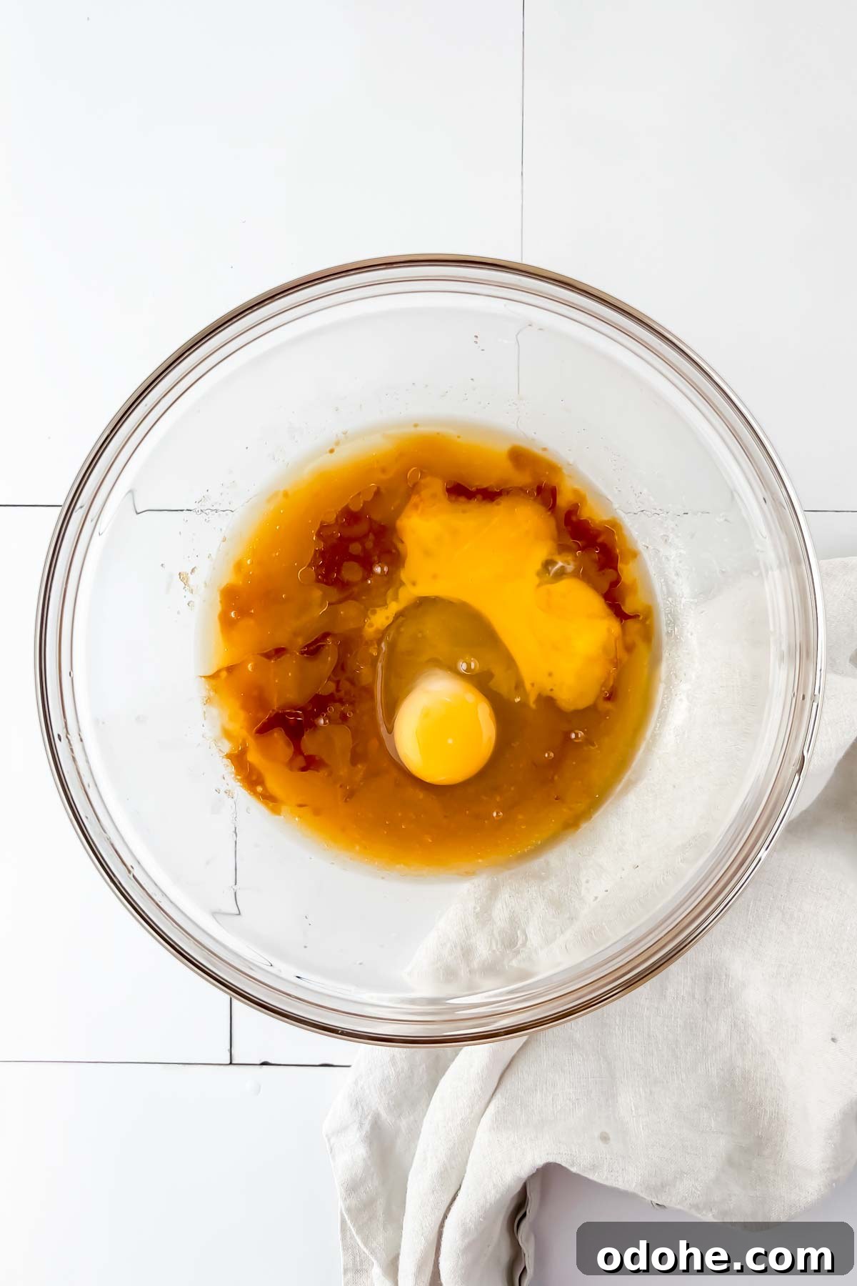 butter, sugar and eggs mixed in glass mixing bowl.