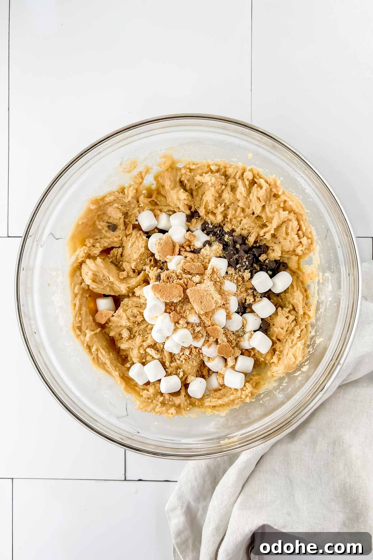 Smores casserole ingredients in glass bowl before mixing.