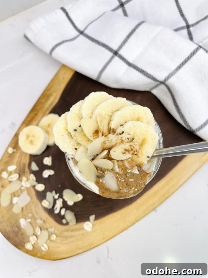 Creamy Almond Butter Overnight Oats Recipe 4 birdseye view of a jar of almond butter overnight oats with banana slices on top