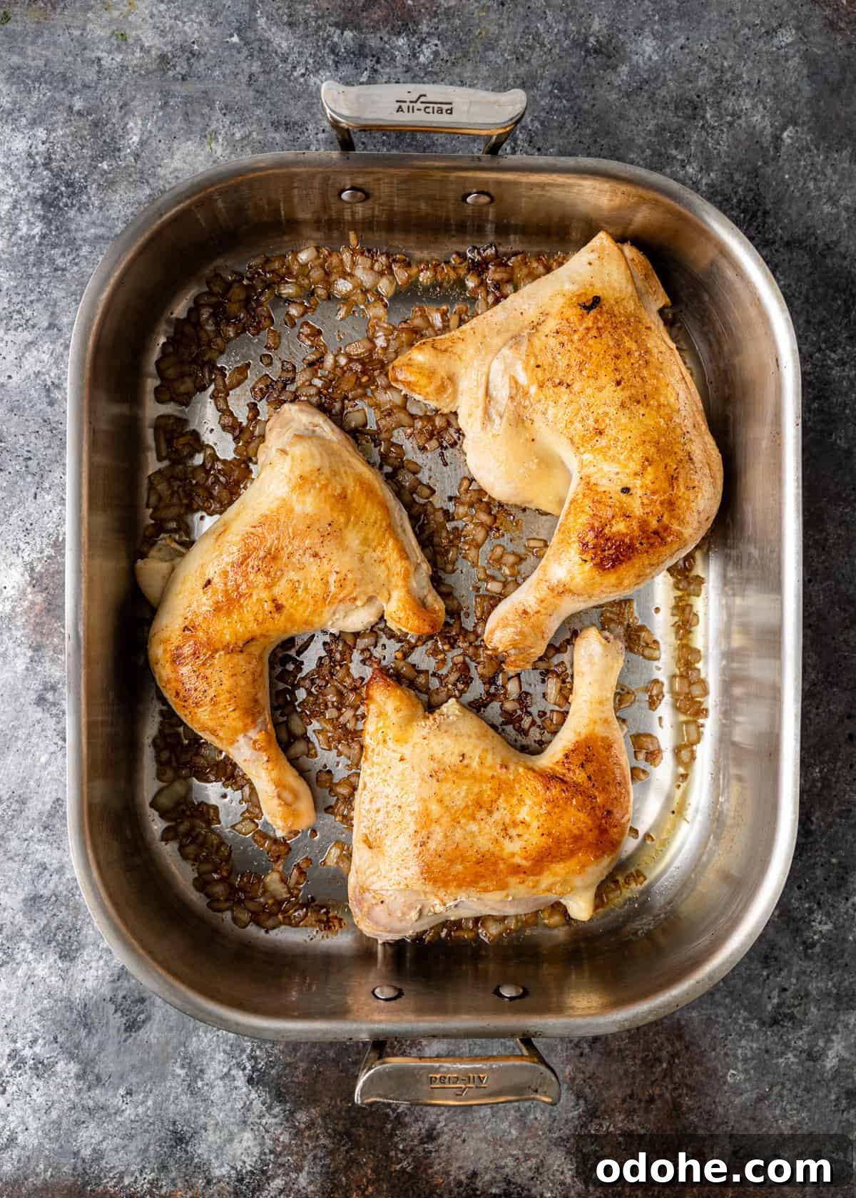 Authentic Kabsa: Arabic Chicken and Rice Recipe 5 overhead: browned chicken thighs and legs in roasting pan