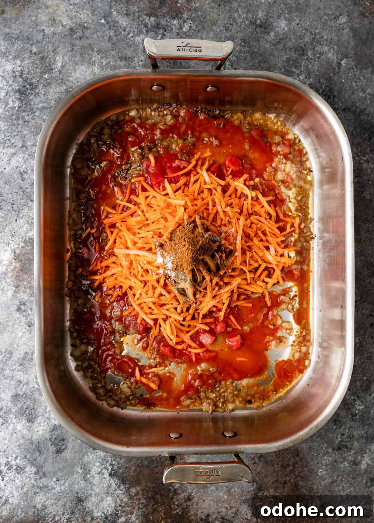 Authentic Kabsa: Arabic Chicken and Rice Recipe 6 overhead: uncooked long grain rice in bottom of roasting pan with tomato sauce and middle eastern spices