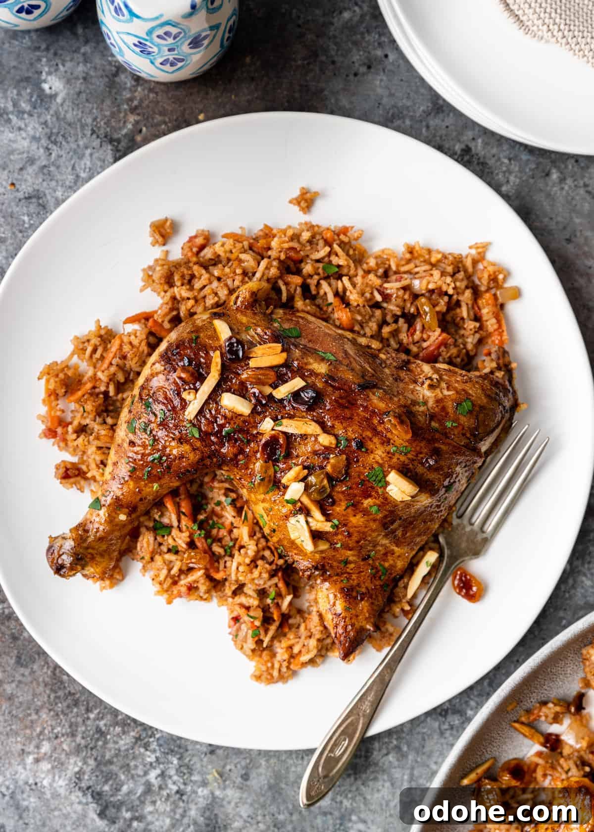 Authentic Kabsa: Arabic Chicken and Rice Recipe 9 overhead: middle eastern chicken and rice called kabsa on white plate with fork