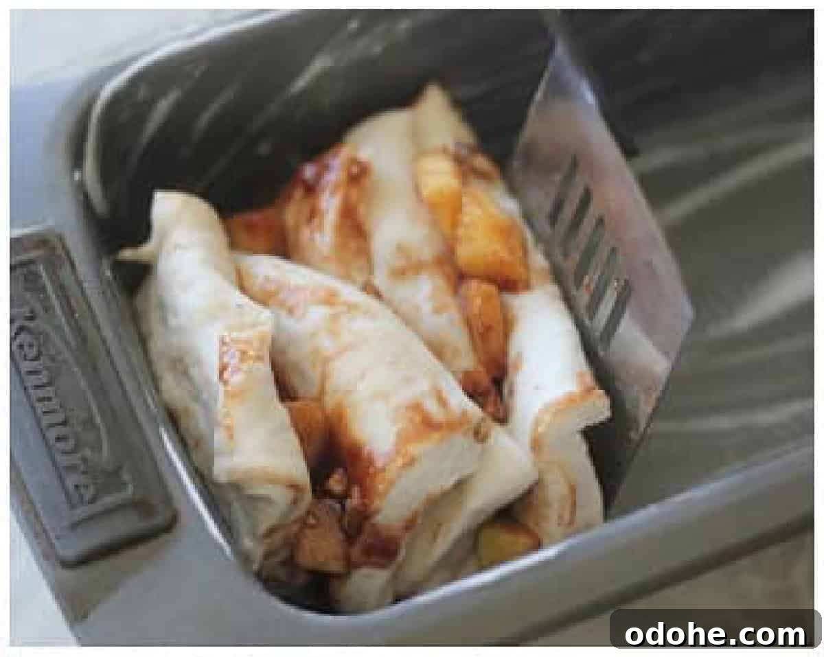 Apple Cinnamon Pull-Apart Bread Recipe 11 Slices of bread dough cut into squares, stacked and placed inside greased loaf pan.