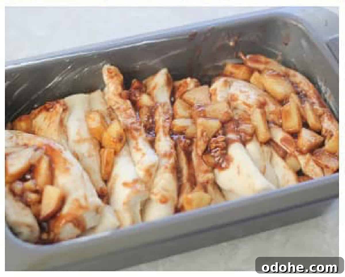 Apple Cinnamon Pull-Apart Bread Recipe 12 Loaf pan of bread slices with apple filling.