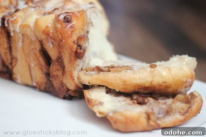 Apple Cinnamon Pull-Apart Bread Recipe 15 Slices of apple pull apart bread on white cutting board.