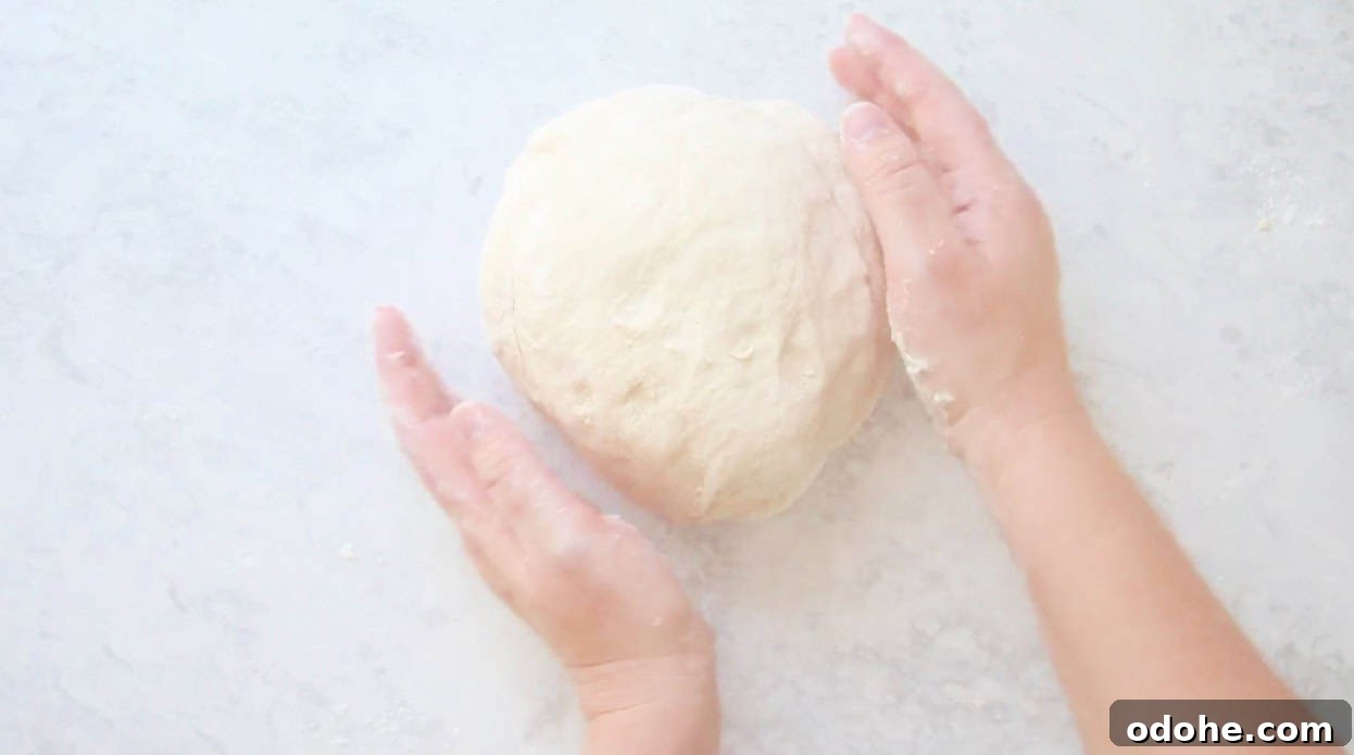 Apple Cinnamon Pull-Apart Bread Recipe 6 Hand kneading ball of bread dough.