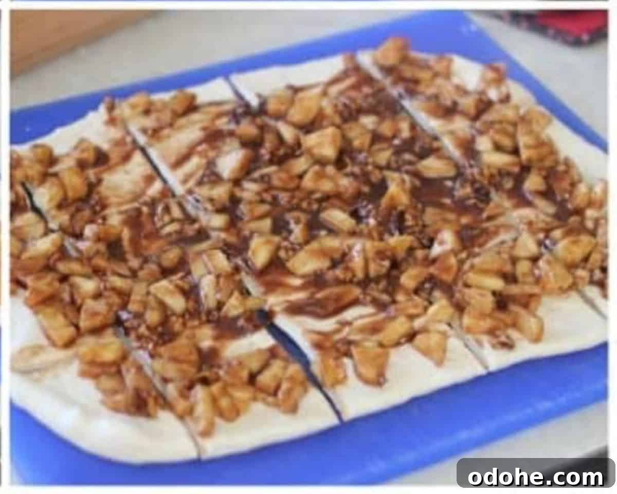 Apple Cinnamon Pull-Apart Bread Recipe 10 Apple filling spread over rolled out bread dough and cut into squares.